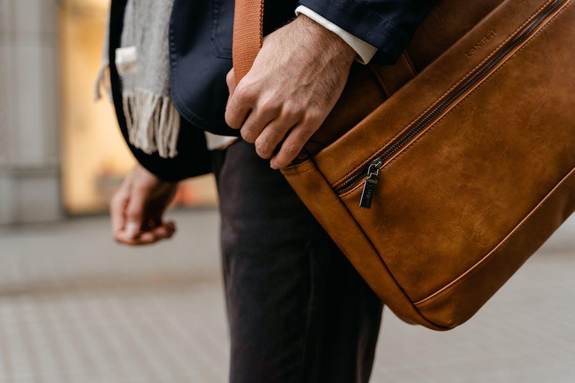 Free Person in Blue Long Sleeve Shirt and Brown Sling Bag Stock Photo