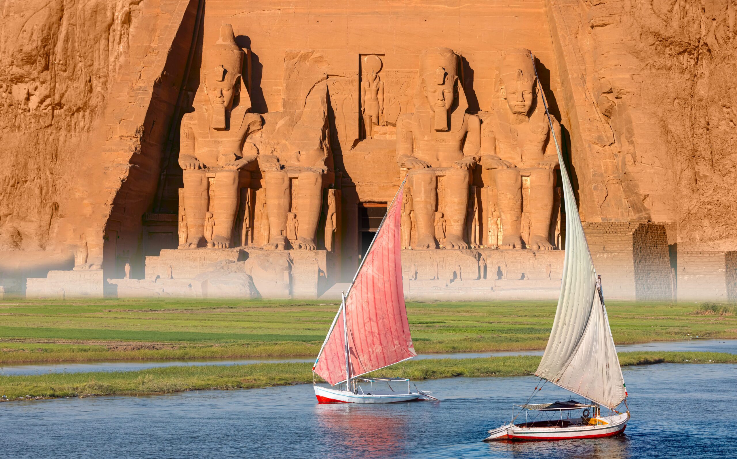 Beautiful Nile scenery with sailboat in the Nile on the way to The Front of the Abu Simbel Temple - Egypt, Africa