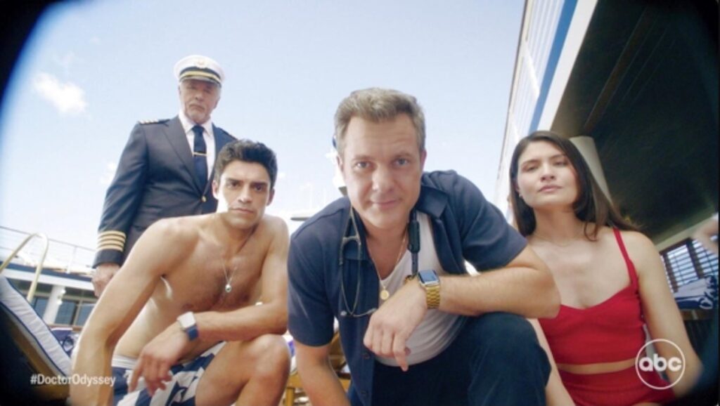 The cast of Doctor Odyssey - Don Johnson, Sean Teale, Joshua Jackson, and Philippa Soo - peer down at the camera, in a POV shot from someone lying flat on a cruise ship's top deck. CREDIT: ABC.