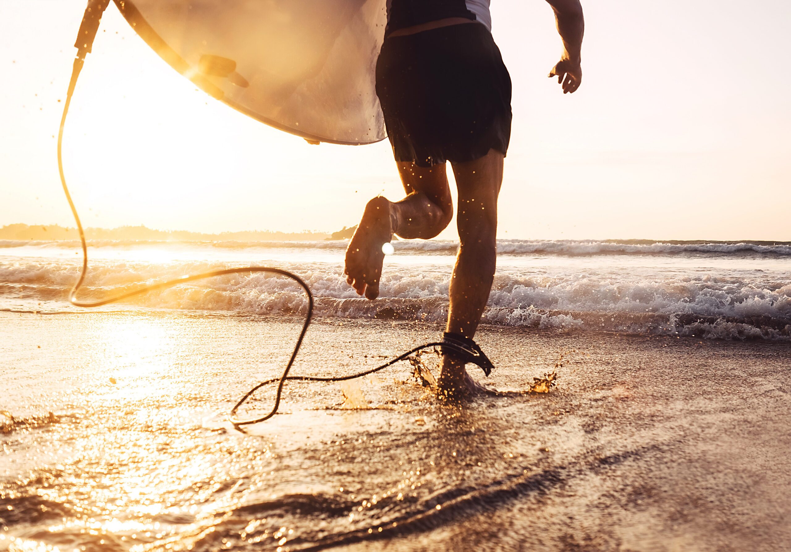 Man surfer run in ocean with surfboard