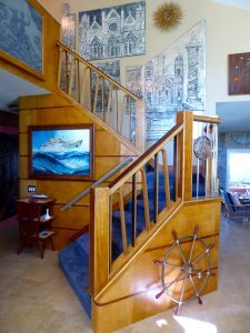 Melamine panels by Emanuele Luzzati from SS AUSONIA (1957), railing from Cunard's SS IVERNIA (1955), maple and mahogany paneling from SS OLYMPIA (1953), starburst from SS EMPRESS OF CANADA (later Carnival's MARDI GRAS), etched glass panel and small serving station from MV AUGUSTUS (1953), steering wheel from Cunard's SS SAXONIA (1954).